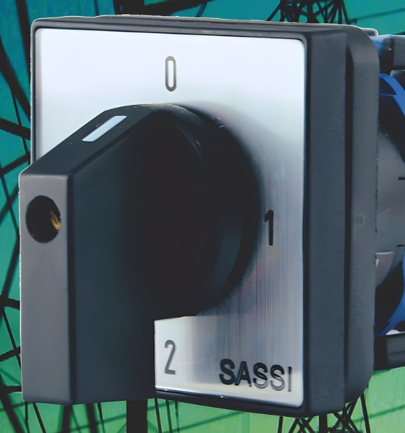 Chave comutadora SASSI com seletor rotativo de três posições (0, 1 e 2), utilizada para comutação de circuitos elétricos em painéis industriais.